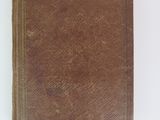 an old book on a white surface with a white background