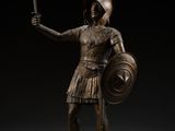 a bronze statue of a roman soldier holding a sword and shield