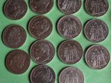 a lot of coins that are on a green surface