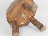 a wooden object that is sitting on a white surface