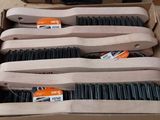 a lot of brushes in a box on the floor