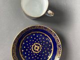 a close up of a cup and saucer on a table