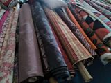 a lot of different colored fabrics on a table
