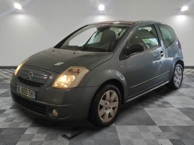 a picture of a grey car parked in a garage