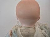 a close up of a doll ' s head on a table