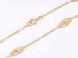 a pair of gold chain bracelets on a white background