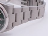 a close up of a watch on a white surface