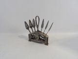a silver spoon and spoon holder with spoons on it