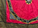 a red and black cloth with a gold medallion on it