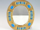 an image of a gold and blue ring on a white surface