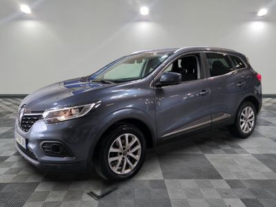 a grey car is parked in a room with a checkered floor