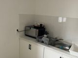 a kitchen with a sink and a microwave in it