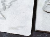 two pieces of clay with a bird on them