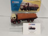 a toy truck and a box on a white surface