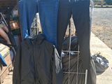 a cart with clothes and bags in it on the side of the road