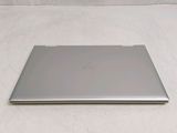 a laptop that is sitting on a white surface