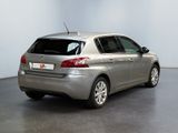the back end of a silver car is parked in a room