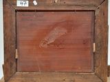 painting of a bird in a wooden frame on a table