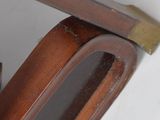 a wooden chair with a wooden seat and a wooden arm rest