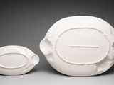 a white bowl and a white bowl sitting on a table