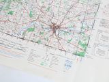 a map of a city on a table next to a cup of coffee