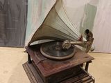 an old record player sitting on top of a wooden table