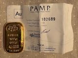 a small piece of gold that is sitting on a piece of paper