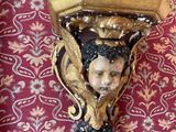 a wall sconce that has a picture of a woman on it