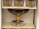 six wine glasses in a cardboard box with gold accents