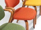 many colorful chairs lined up in a row on the floor