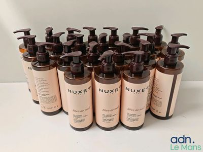 many bottles of liquid are lined up on a table