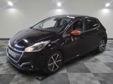a black car is parked in a room with a checkered floor