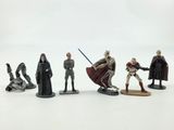star wars figurines sit on a white surface with a white background