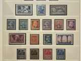 framed picture of a collection of stamps from different countries on display in a glass case