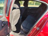 a red car with the door open and the seat up