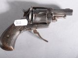 an old gun with a tag on it sitting on a table