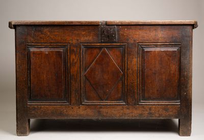 an old wooden chest sitting on top of a white floor