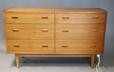 an image of a wooden chest of drawers on a grey background
