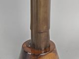 statue of a man in a tuxedo on a wooden base