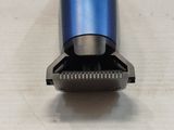 a close up of a blue shaver on a table