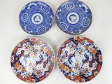 three blue and white plates with flowers and birds on them