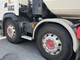 a dump truck that is parked on the side of the road