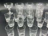 a lot of glasses that are sitting on a table
