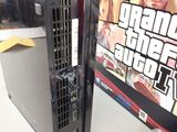 a computer that is sitting on a table in front of a video game