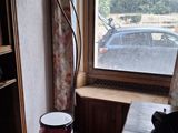 une petite pièce avec une table, une chaise et une lampe