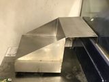 a stainless steel table that has a piece of metal on it