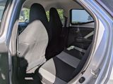 a seat in the back of a car with a black seat cover