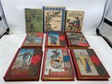 six children ' s books sitting on top of a white table