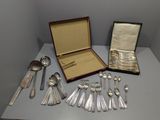 a lot of silver spoons and spoons on a table