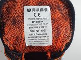 the back of a pair of orange and black shoes with a label on it